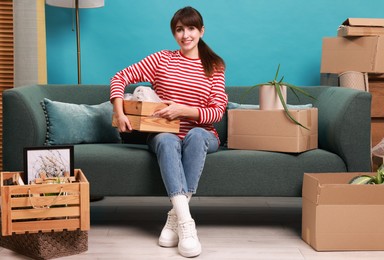 Photo of Happy woman with moving boxes in new apartment. Housewarming party