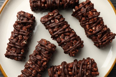 Photo of Delicious chocolate puffed rice bars on table, closeup