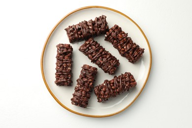 Photo of Delicious chocolate puffed rice bars on white table, top view