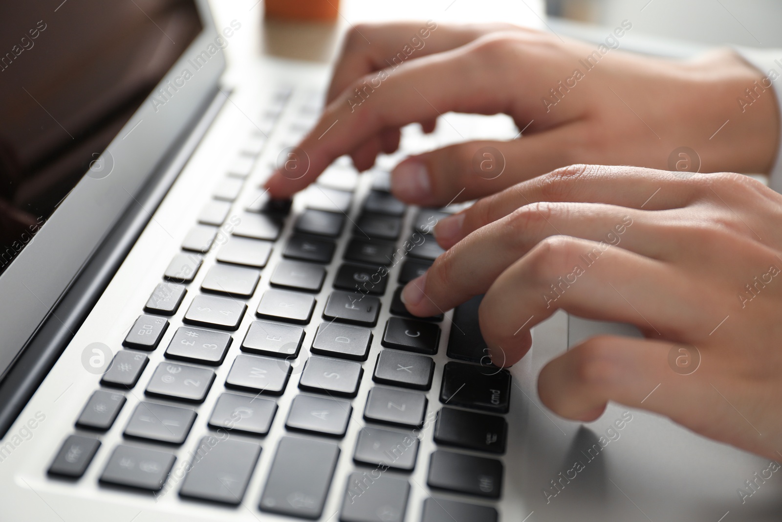 Photo of Businesswoman using laptop indoors, closeup. Modern technology