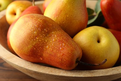 Photo of Ripe juicy pears on wooden table, closeup