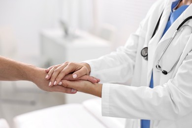 Healthcare worker supporting patient in hospital, closeup