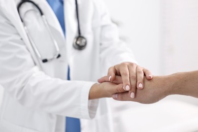 Photo of Healthcare worker supporting patient in hospital, closeup