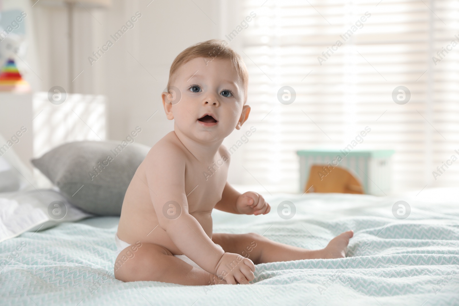 Photo of Cute little baby on bed at home