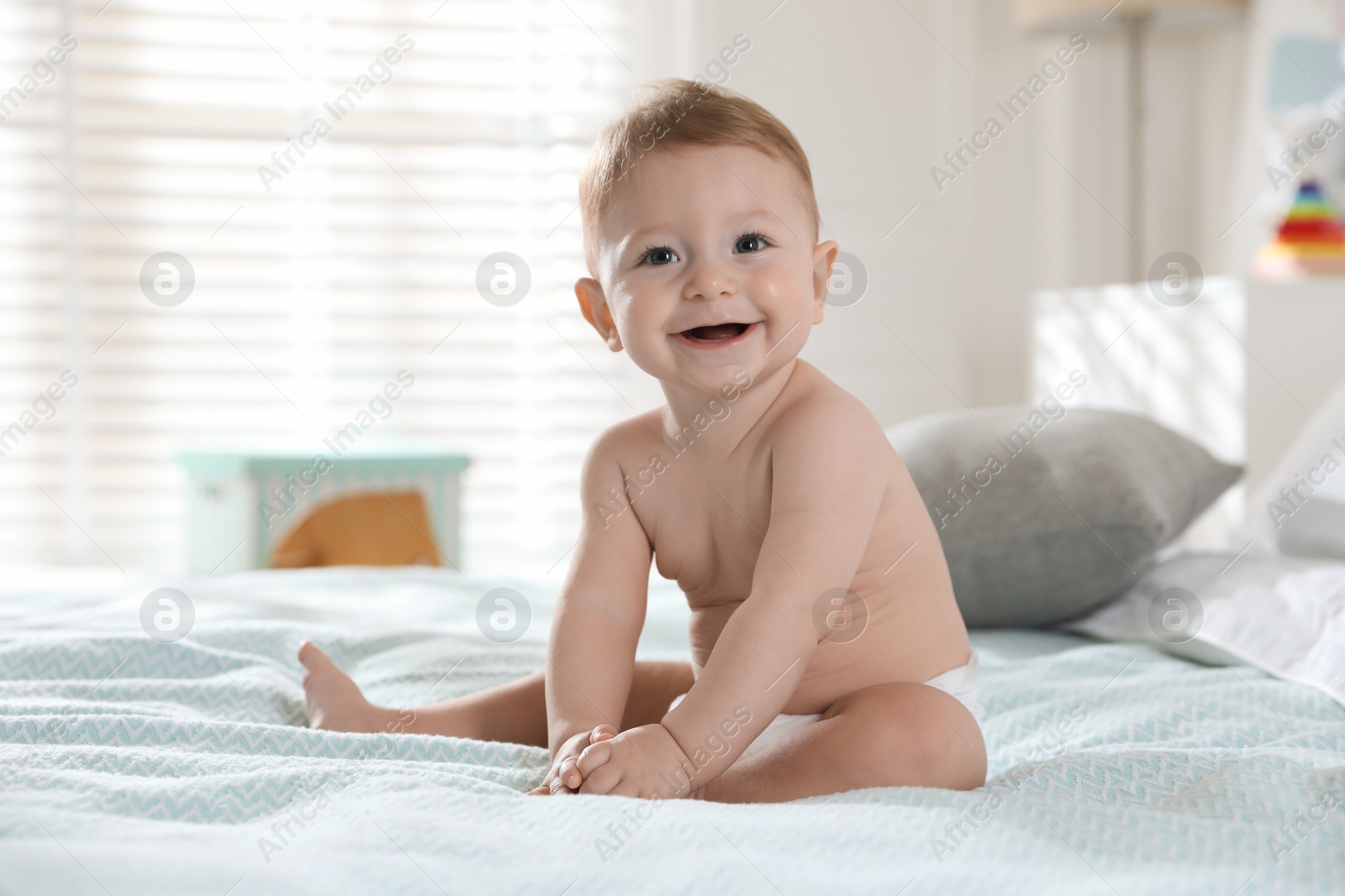 Photo of Cute little baby on bed at home