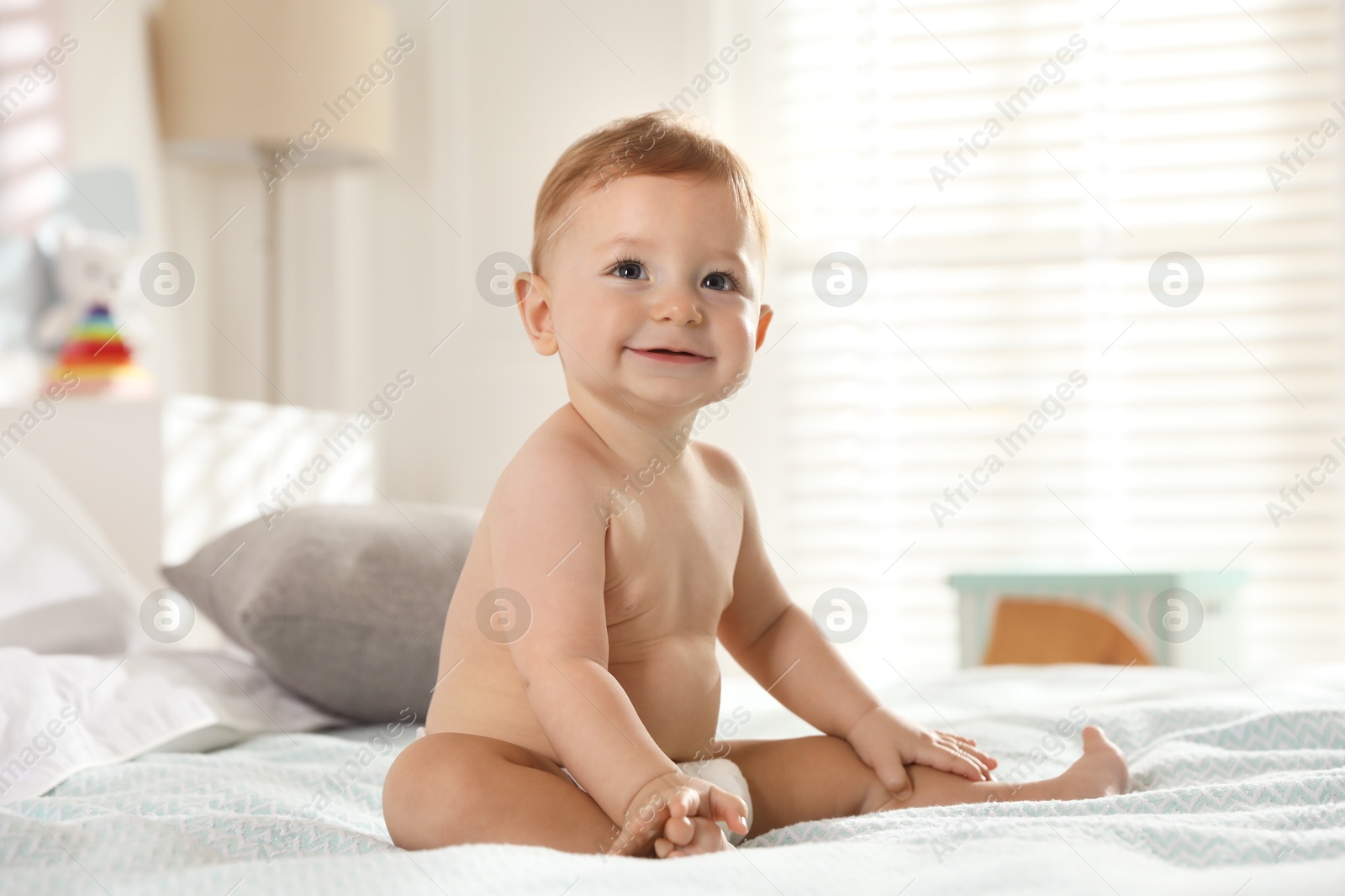 Photo of Cute little baby on bed at home