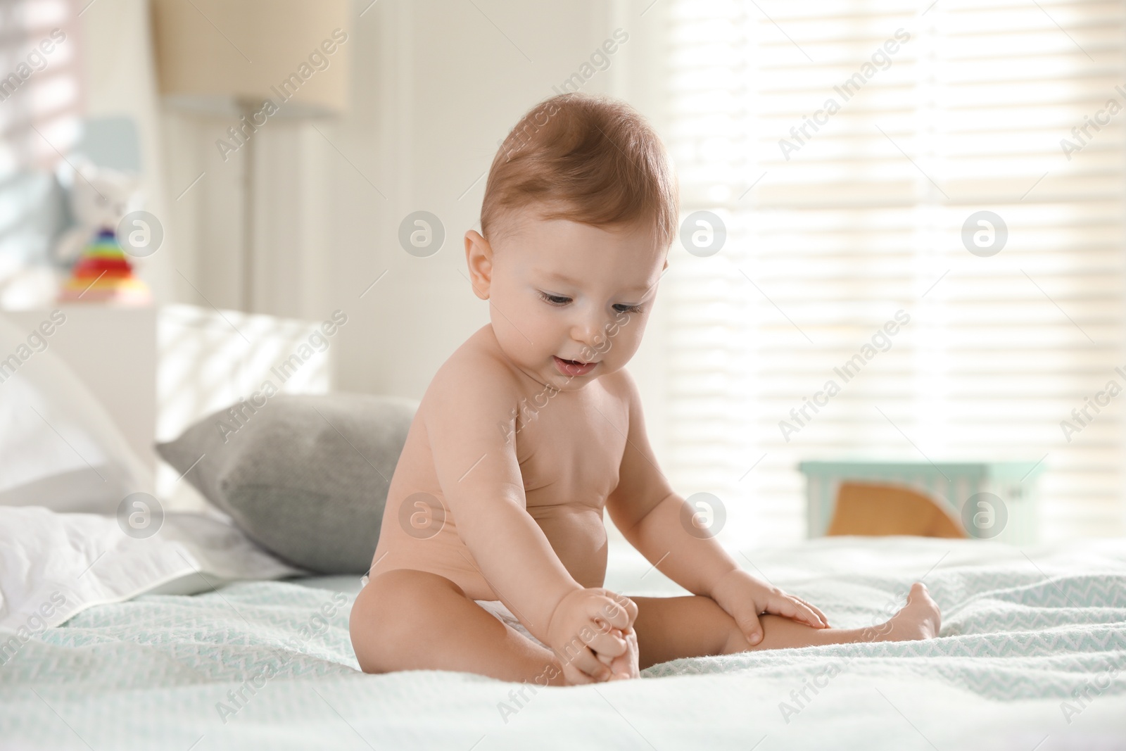 Photo of Cute little baby on bed at home