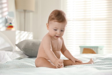 Photo of Cute little baby on bed at home