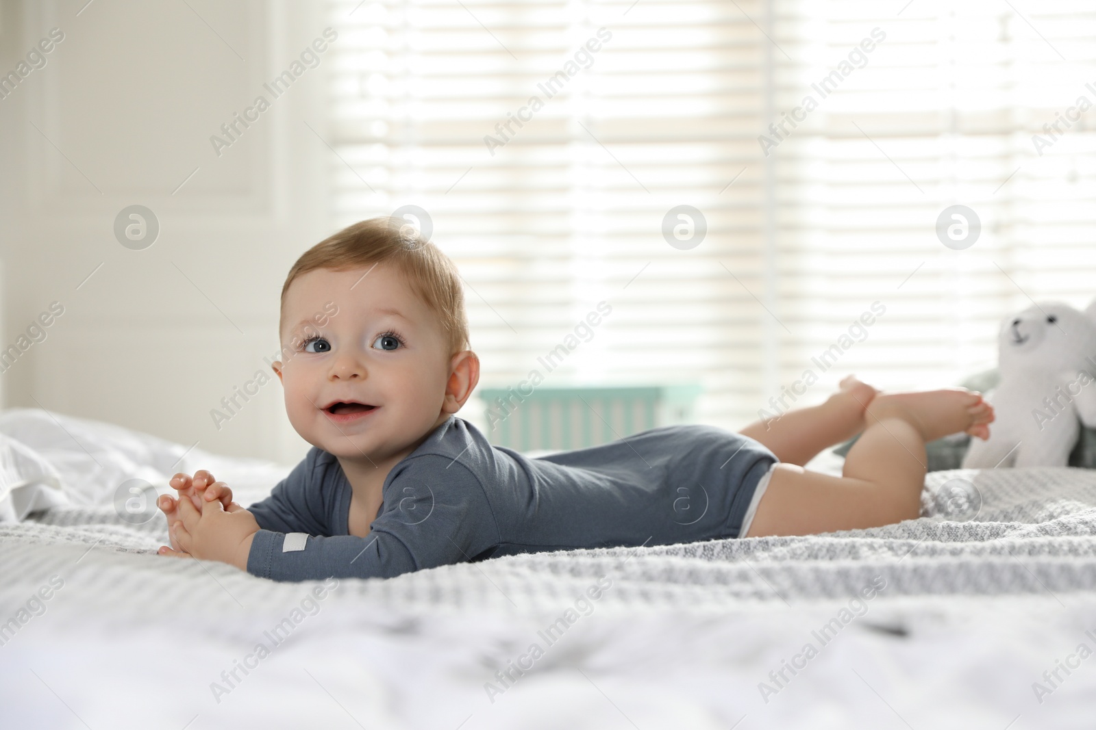 Photo of Cute little baby on bed at home