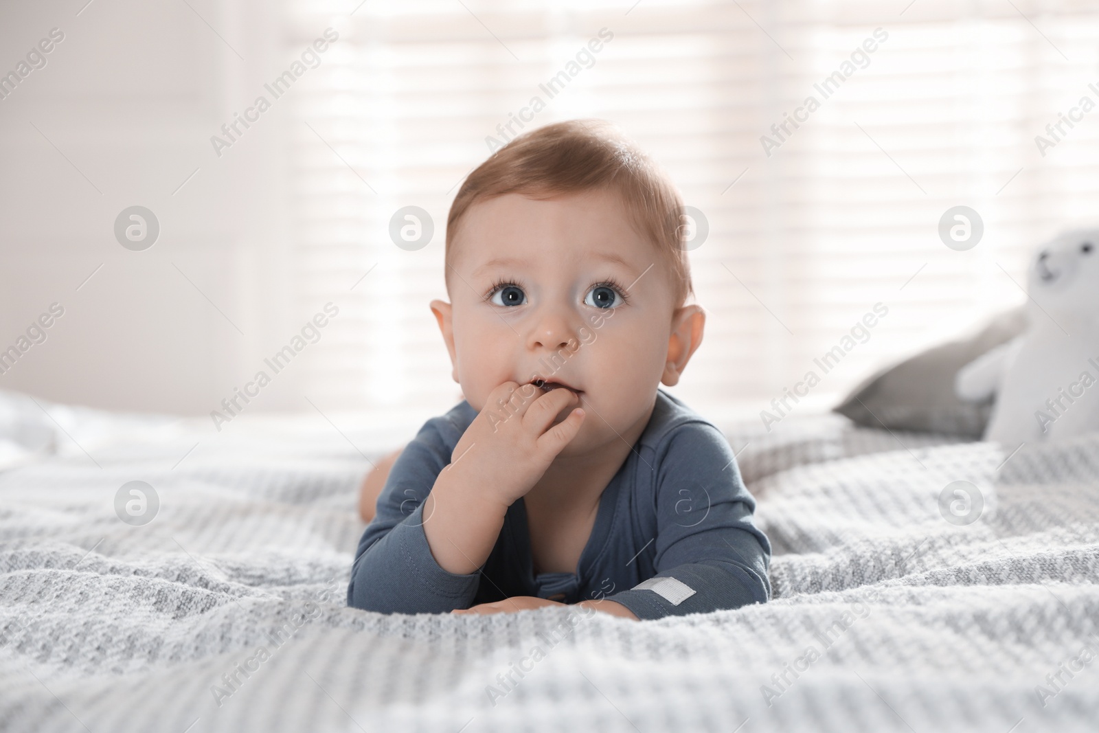 Photo of Cute little baby on bed at home