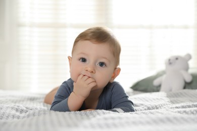 Photo of Cute little baby on bed at home