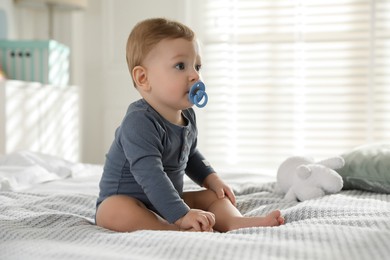 Photo of Cute little baby on bed at home