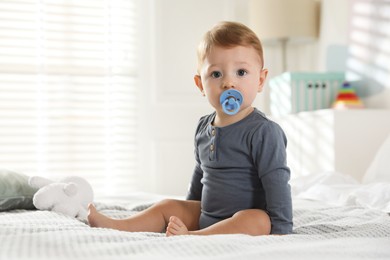 Photo of Cute little baby on bed at home