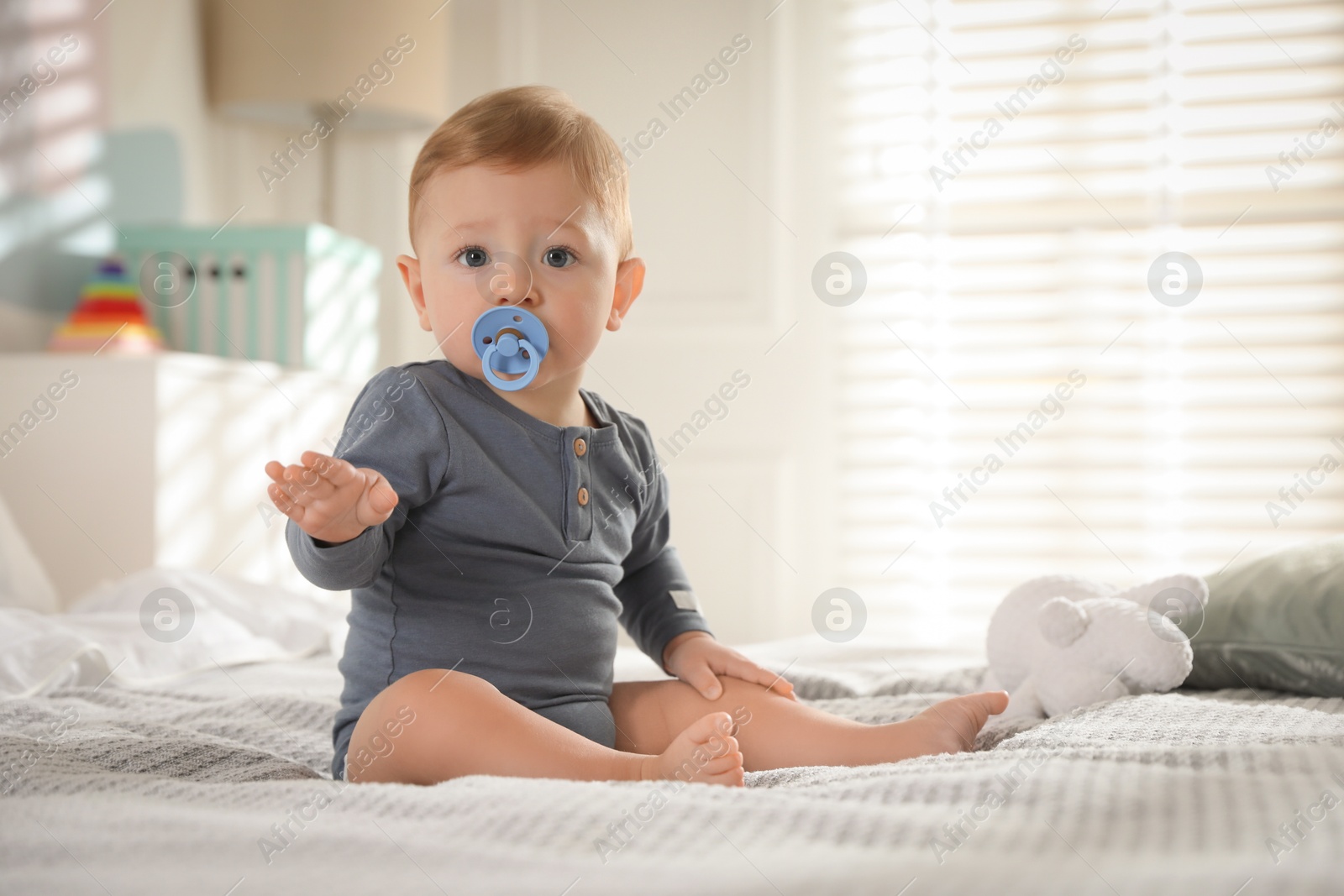 Photo of Cute little baby on bed at home