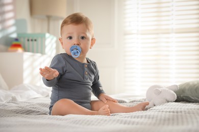 Cute little baby on bed at home