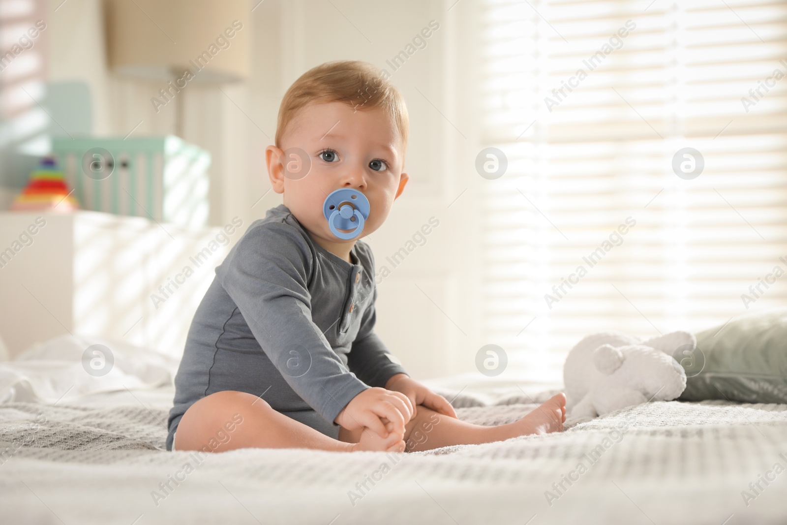 Photo of Cute little baby on bed at home