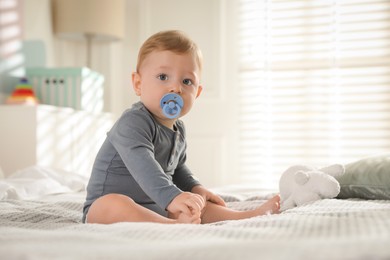 Photo of Cute little baby on bed at home