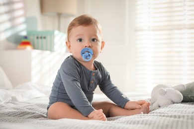 Photo of Cute little baby on bed at home