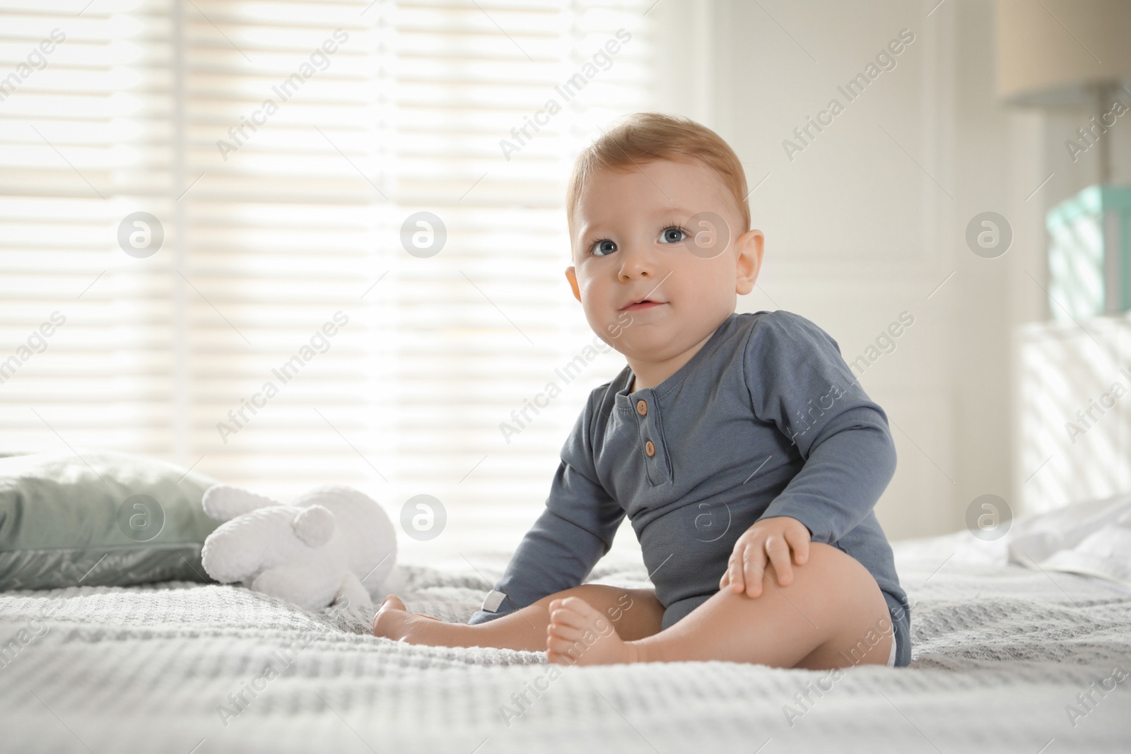 Photo of Cute little baby on bed at home