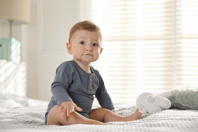 Photo of Cute little baby on bed at home