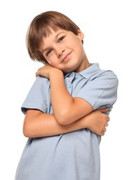 Cute little boy hugging himself on white background