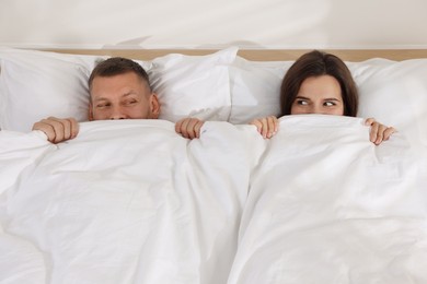 Lovely couple lying in bed at home