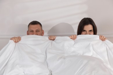 Photo of Lovely couple lying in bed at home