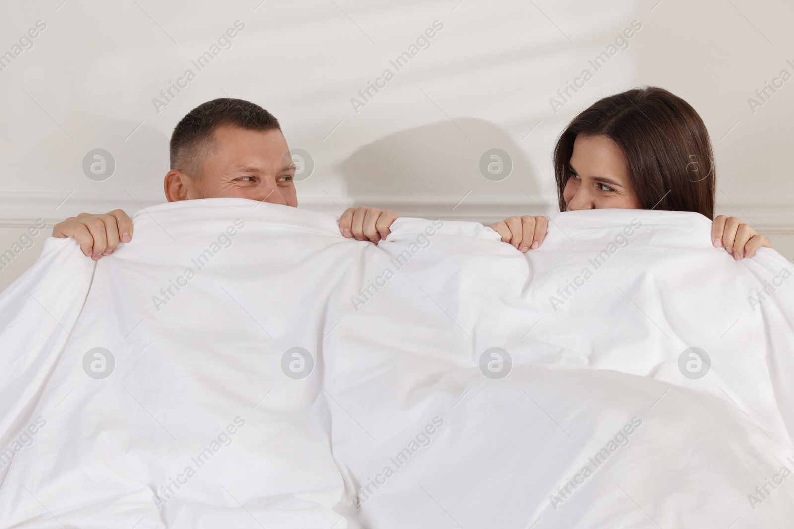 Photo of Lovely couple lying in bed at home