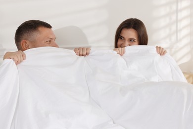 Photo of Lovely couple lying in bed at home