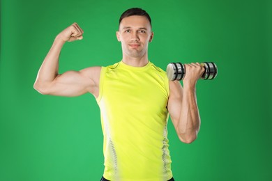 Photo of Man exercising with dumbbell on green background