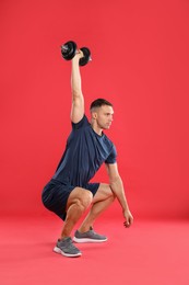 Photo of Man exercising with barbell on red background