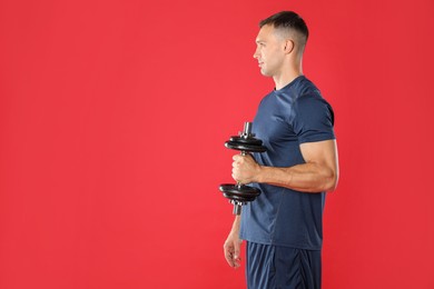 Photo of Man exercising with barbell on red background, space for text