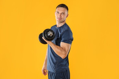 Photo of Man exercising with barbell on yellow background