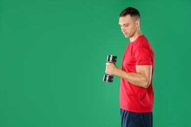 Photo of Man exercising with dumbbell on green background, space for text