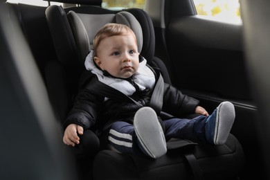 Cute little baby sitting in car seat