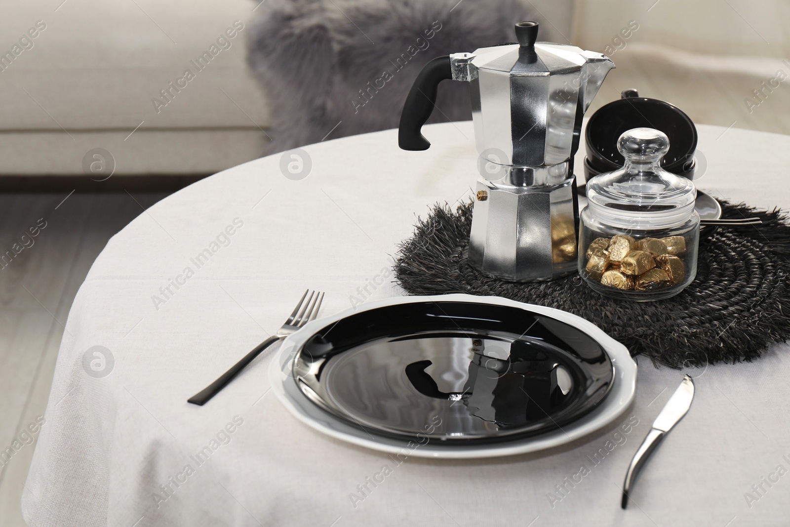 Photo of Stylish table setting with black dishware in dining room