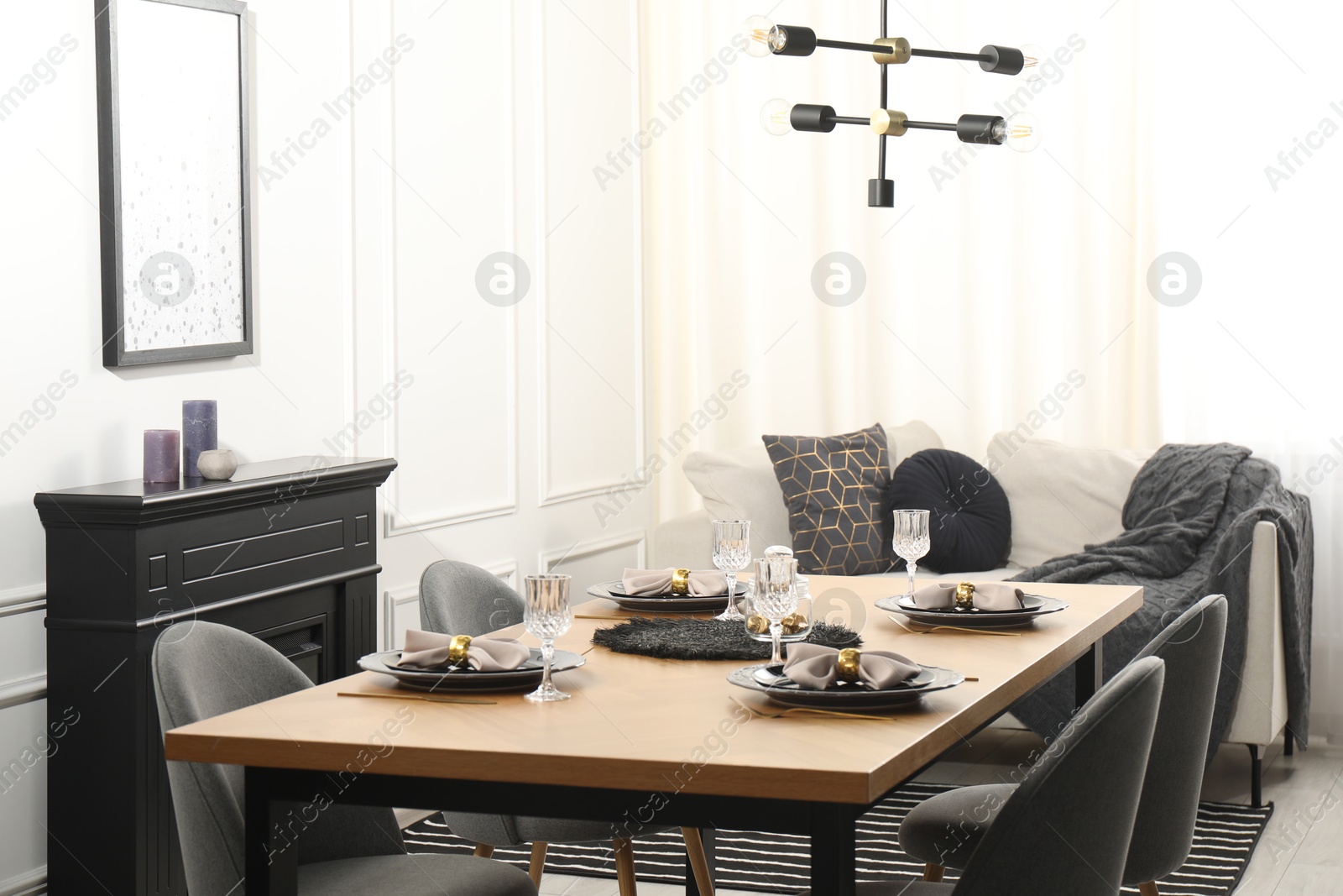 Photo of Stylish table setting with black dishware in dining room