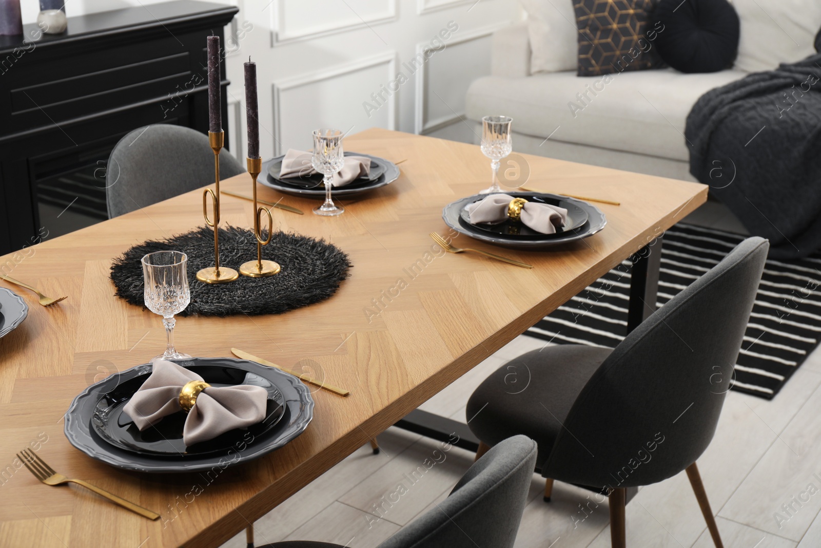 Photo of Stylish table setting with black dishware in dining room