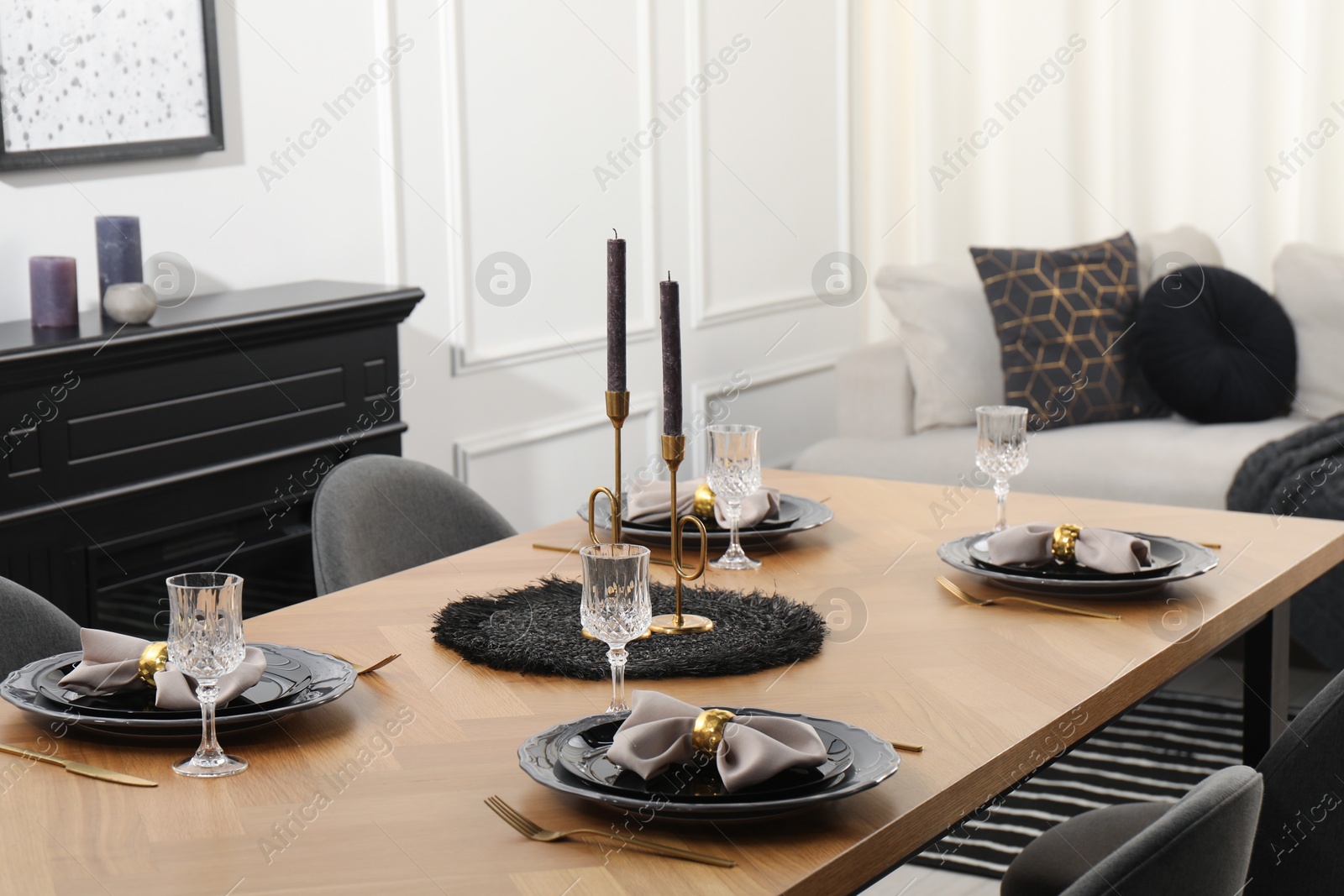 Photo of Stylish table setting with black dishware in dining room