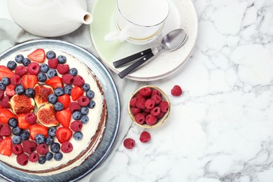 Photo of Delicious chocolate sponge cake with berries served on white marble table, flat lay