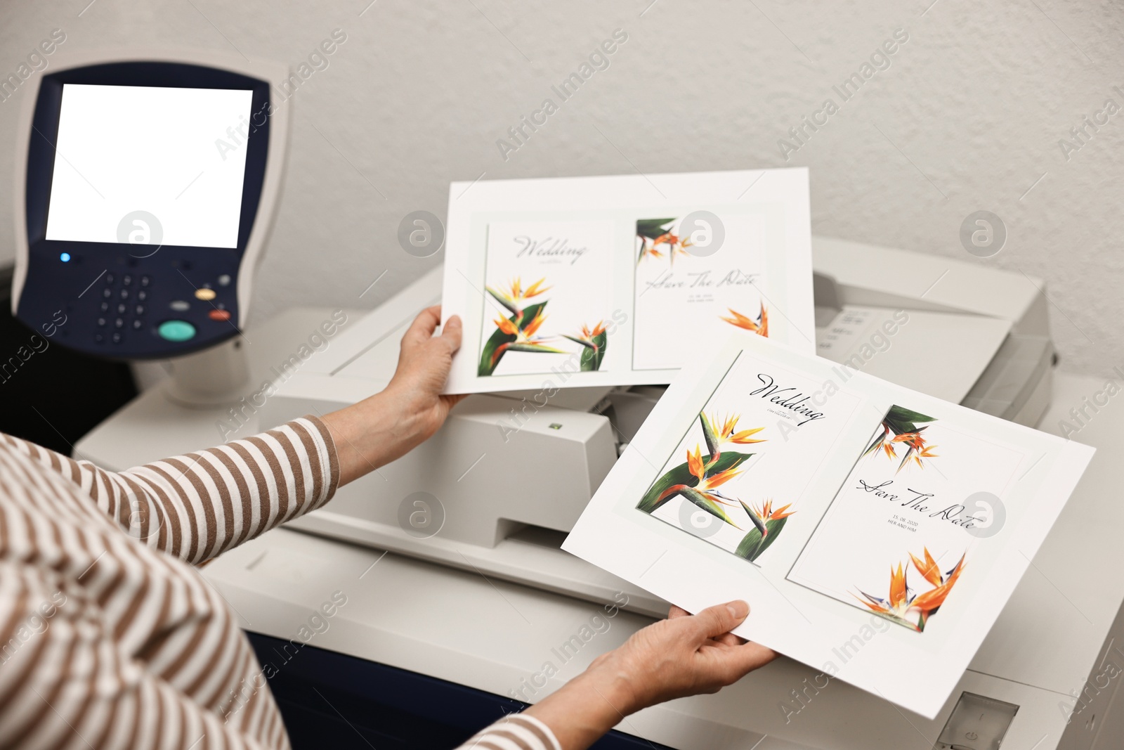 Photo of Woman using modern printer indoors, closeup. Printing house