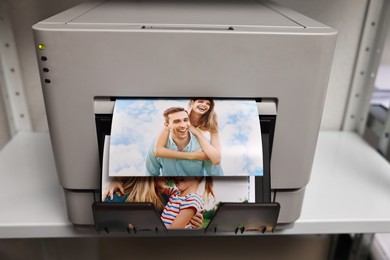 Photo of Modern printer with colorful photos indoors, closeup