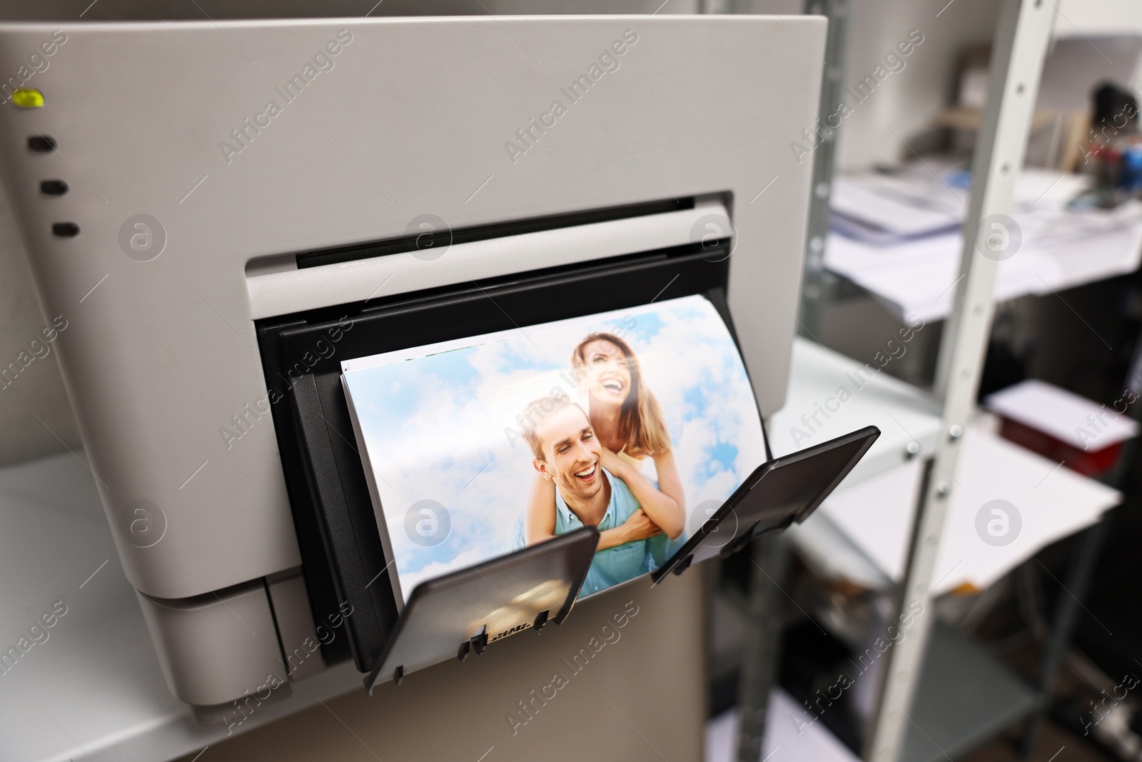 Photo of Modern printer with colorful photo indoors, closeup