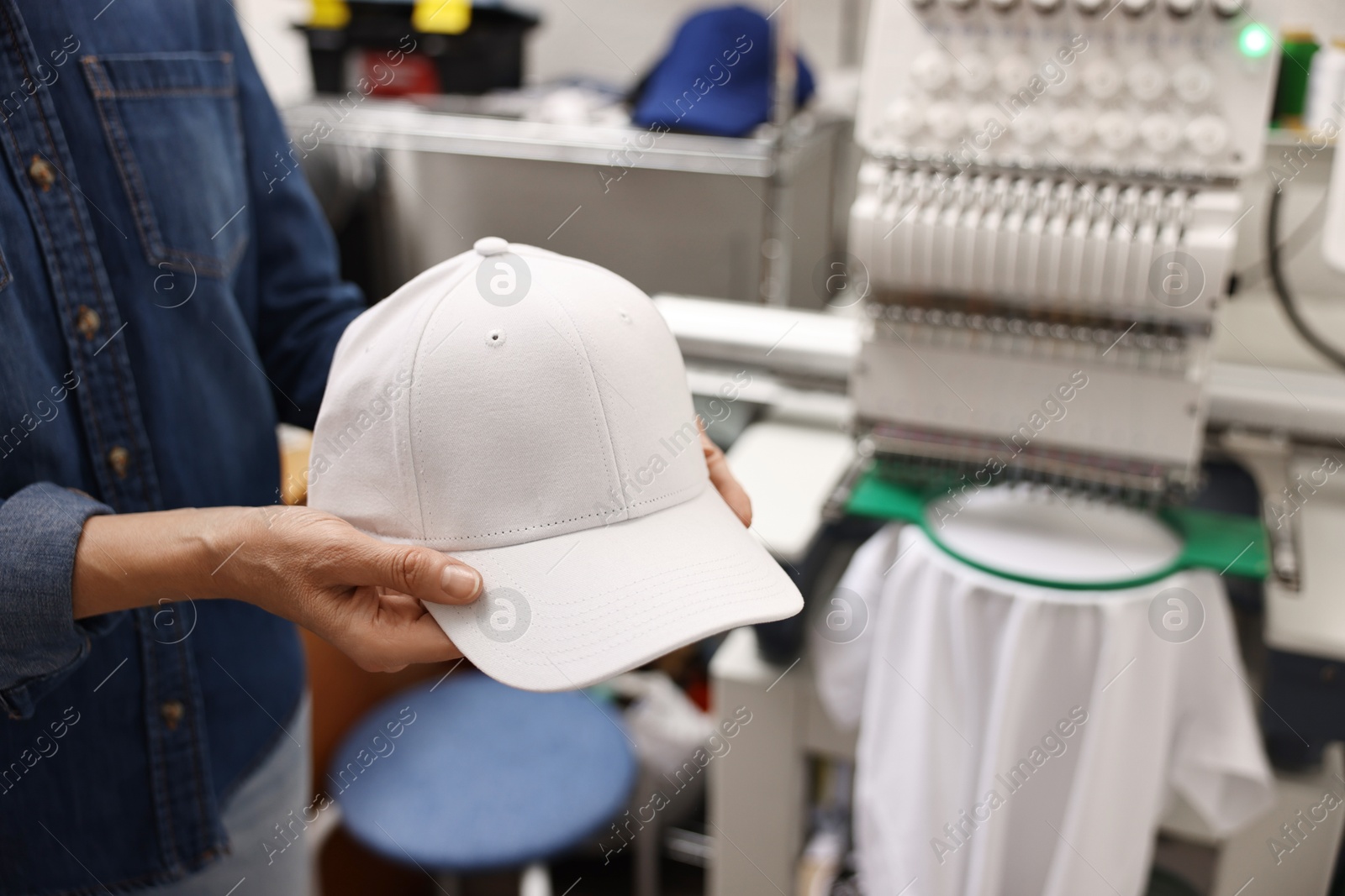 Photo of Woman with blank baseball cap for print indoors, closeup