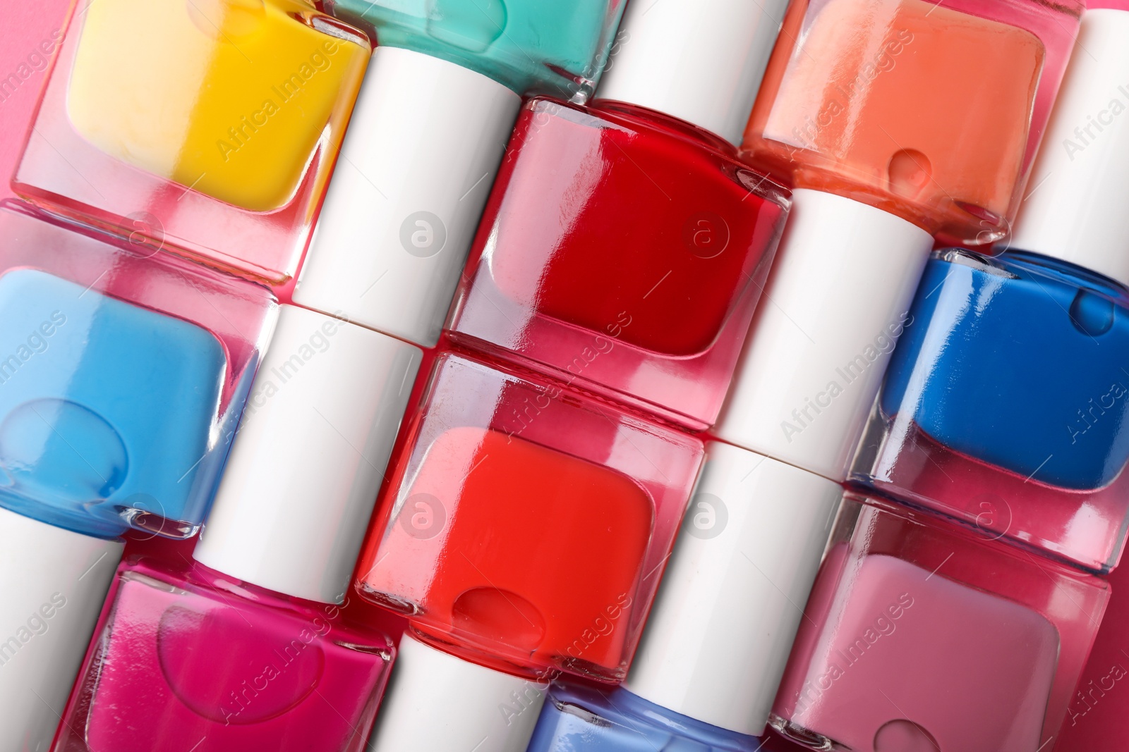 Photo of Set of different nail polishes as background, top view