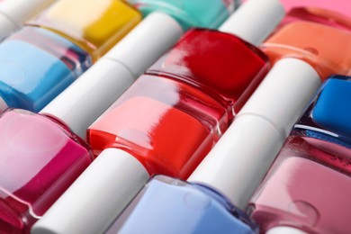 Photo of Set of different nail polishes as background, closeup