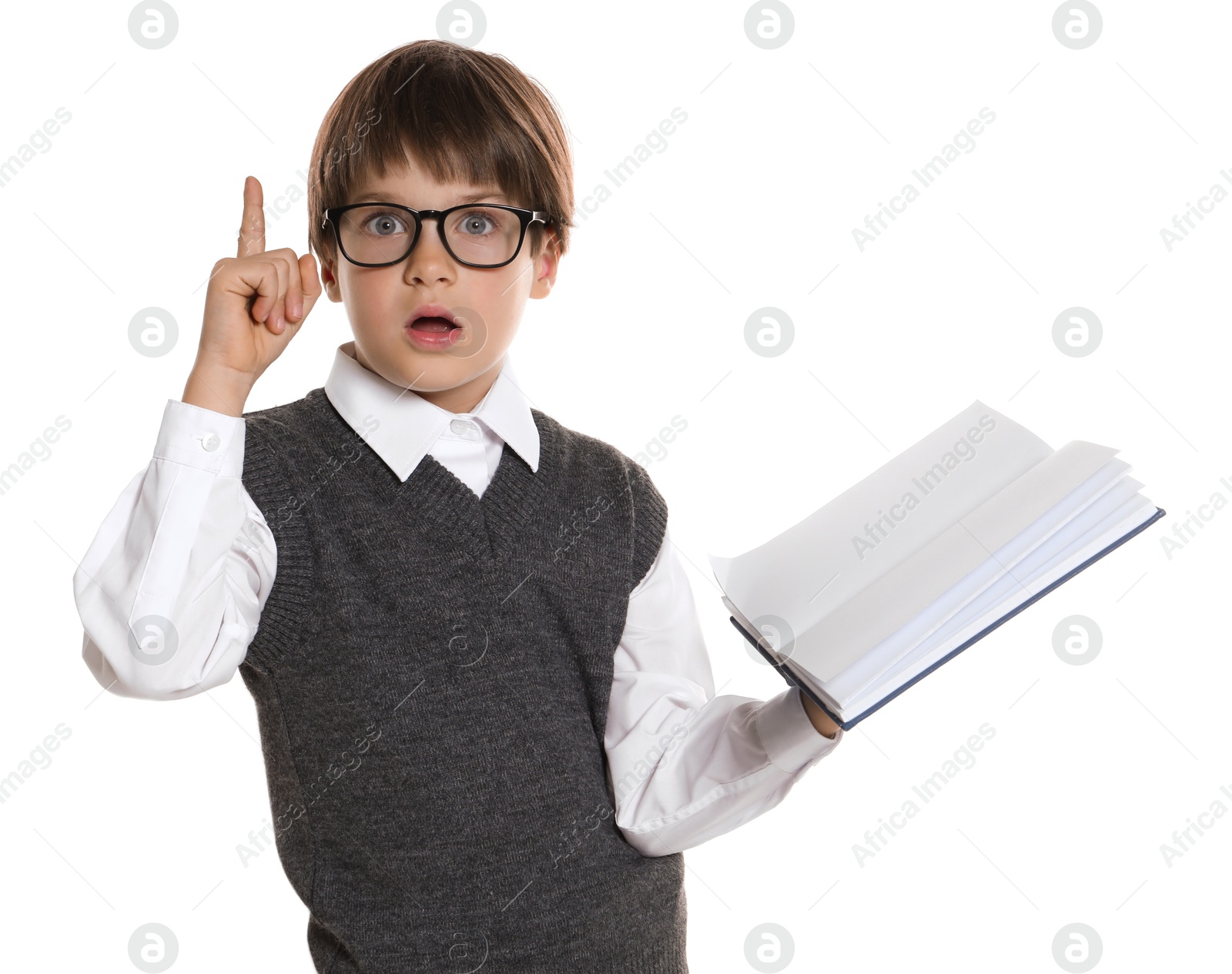 Photo of Learning alphabet. Little boy with book pointing at something on white background