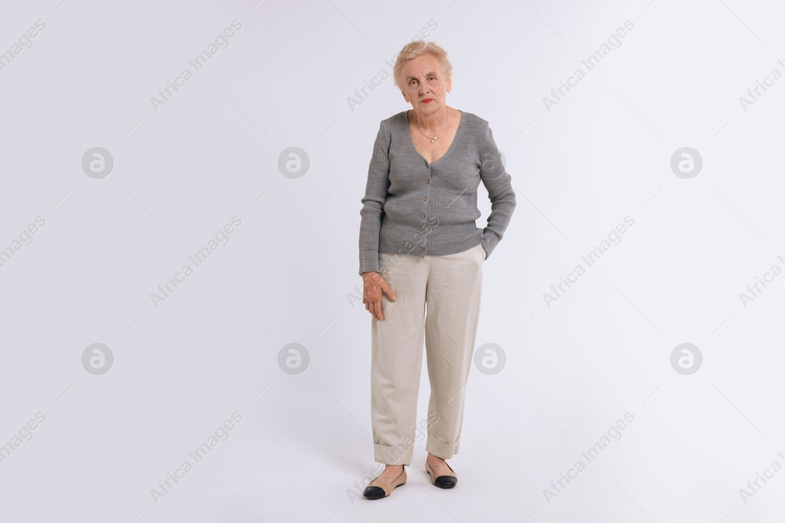 Photo of Full length portrait of senior woman on white background