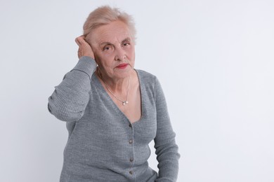 Photo of Portrait of senior woman on white background. Space for text