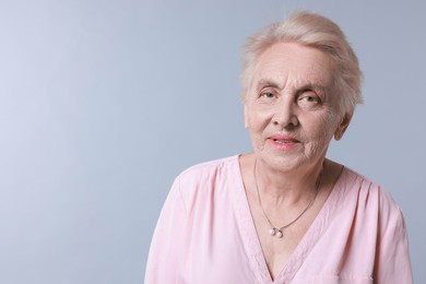 Photo of Portrait of senior woman on light background. Space for text